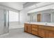 Bright bathroom features a tub, walk-in shower, double vanity and marble countertop at 7910 E Navarro Ave, Mesa, AZ 85209