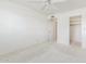 Bedroom with neutral carpet, ceiling fan, and ensuite access to bath at 7910 E Navarro Ave, Mesa, AZ 85209