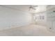 Light-filled bedroom with neutral carpeting, wallpaper and a door leading outside at 7910 E Navarro Ave, Mesa, AZ 85209
