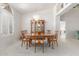 Elegant dining room with a chandelier, wooden table, and natural light at 7910 E Navarro Ave, Mesa, AZ 85209