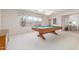 Spacious game room featuring a pool table, large window, and carpeted floor at 7910 E Navarro Ave, Mesa, AZ 85209