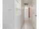 Hallway featuring built-in shelving with glass accents and tiled flooring at 7910 E Navarro Ave, Mesa, AZ 85209