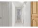 Well-lit hallway with tiled flooring and paneled doors, leading to other rooms at 7910 E Navarro Ave, Mesa, AZ 85209