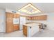 Bright kitchen features an island, modern appliances, and abundant wood cabinetry at 7910 E Navarro Ave, Mesa, AZ 85209