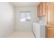 Spacious laundry room with cabinetry, natural light and tile floor at 7910 E Navarro Ave, Mesa, AZ 85209