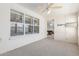 Well-lit room with neutral carpet and a ceiling fan with view into a game room at 7910 E Navarro Ave, Mesa, AZ 85209