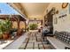 Cozy covered back porch featuring a seating area with an outdoor rug and a vibrant garden view at 861 E Indian Wells Pl, Chandler, AZ 85249