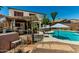 Beautifully landscaped backyard with an outdoor kitchen, hot tub and a sparkling pool at 861 E Indian Wells Pl, Chandler, AZ 85249