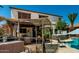 Expansive backyard with an outdoor kitchen area, hot tub, and a sparkling pool at 861 E Indian Wells Pl, Chandler, AZ 85249