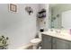 Half-bathroom featuring a sink with a gray cabinet, a toilet, and a framed picture at 861 E Indian Wells Pl, Chandler, AZ 85249