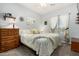 Charming bedroom with patterned bedding, decorative shelves, and a window with curtains at 861 E Indian Wells Pl, Chandler, AZ 85249