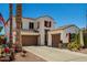 Attractive Southwest-style home with a three-car garage, and red shutters, complemented by desert landscaping at 861 E Indian Wells Pl, Chandler, AZ 85249