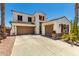 Southwest-style home with a three-car garage, desert landscaping, and red shutters, showing curb appeal at 861 E Indian Wells Pl, Chandler, AZ 85249