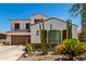 Southwest-style two-story home with desert landscaping, including cacti and palm trees, providing curb appeal at 861 E Indian Wells Pl, Chandler, AZ 85249