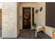 Inviting front porch with a wooden door, decorative wreath, and bench seating, creating a warm welcome at 861 E Indian Wells Pl, Chandler, AZ 85249