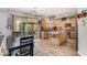 Eat in kitchen featuring wood cabinets, a kitchen island, and a sliding glass door to the outdoor area at 861 E Indian Wells Pl, Chandler, AZ 85249