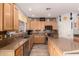 Well-lit kitchen featuring wood cabinets, granite countertops, and stainless steel appliances at 861 E Indian Wells Pl, Chandler, AZ 85249