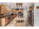 Well-lit kitchen featuring ample cabinet space, a center island, and stainless steel appliances at 861 E Indian Wells Pl, Chandler, AZ 85249