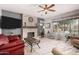 Inviting living room with a stone fireplace, modern ceiling fan, and plenty of natural light at 861 E Indian Wells Pl, Chandler, AZ 85249