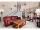 Cozy living room with a large red couch and bright lighting at 861 E Indian Wells Pl, Chandler, AZ 85249