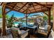 Inviting outdoor patio area featuring a covered seating area and a pristine pool at 861 E Indian Wells Pl, Chandler, AZ 85249