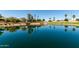 Serene pond with clear reflections, lush landscaping, and walking paths, for relaxing community enjoyment at 861 E Indian Wells Pl, Chandler, AZ 85249