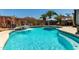 A sparkling in-ground pool has a waterfall feature and ample seating for relaxing and entertaining Gathering and friends at 861 E Indian Wells Pl, Chandler, AZ 85249