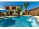 Backyard oasis featuring a sparkling pool, spa, mature palm tree, and covered patio area at 861 E Indian Wells Pl, Chandler, AZ 85249