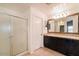 Bathroom featuring a walk-in shower, double sinks with a granite countertop, and tile floors at 8744 W Superior Ave, Tolleson, AZ 85353
