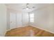 Cozy bedroom with wood floors, a window and a closet with sliding doors at 8744 W Superior Ave, Tolleson, AZ 85353