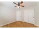 Bright bedroom featuring wood floors, a ceiling fan, and a closet with sliding doors at 8744 W Superior Ave, Tolleson, AZ 85353
