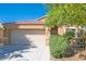 Single-story home featuring a two car garage, tile roof, desert landscaping, and a covered front porch at 8744 W Superior Ave, Tolleson, AZ 85353