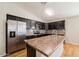 Well-appointed kitchen with stainless steel appliances, dark cabinetry, and a mosaic backsplash at 8744 W Superior Ave, Tolleson, AZ 85353