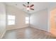 Bright main bedroom featuring vinyl floors, a ceiling fan, and en suite bathroom at 8744 W Superior Ave, Tolleson, AZ 85353