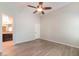 Spacious main bedroom featuring vinyl floors, a ceiling fan, and en suite bathroom at 8744 W Superior Ave, Tolleson, AZ 85353