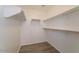 Walk-in closet with vinyl flooring and multiple built in shelves at 8744 W Superior Ave, Tolleson, AZ 85353