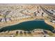 Beautiful aerial view showcasing community's lake, walking paths, and suburban homes at 9835 E Wavelength Ave, Mesa, AZ 85212