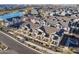 Aerial view of a modern community with townhomes, green spaces, and a beautiful lake at 9835 E Wavelength Ave, Mesa, AZ 85212