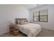 Cozy bedroom with neutral decor, a tufted headboard, and plush bedding near a window at 9835 E Wavelength Ave, Mesa, AZ 85212