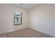 Clean, carpeted bedroom with a window providing natural light and view at 9835 E Wavelength Ave, Mesa, AZ 85212