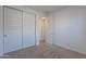 Bright bedroom with white walls, neutral carpet, and closet with sleek sliding doors at 9835 E Wavelength Ave, Mesa, AZ 85212