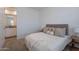 Comfortable bedroom featuring a plush bed, side tables, and a glimpse into the ensuite bathroom at 9835 E Wavelength Ave, Mesa, AZ 85212