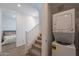 Hallway with stairs leading upstairs, bedroom entrance, and stacked washer and dryer at 9835 E Wavelength Ave, Mesa, AZ 85212