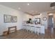 Modern eat-in kitchen with a breakfast bar, white cabinets, and open layout perfect for entertaining at 9835 E Wavelength Ave, Mesa, AZ 85212