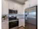 Modern kitchen showcasing stainless steel appliances, elegant white cabinetry, and stylish countertop finishes at 9835 E Wavelength Ave, Mesa, AZ 85212
