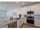 Modern kitchen featuring stainless steel appliances, granite countertops, and white cabinetry at 9835 E Wavelength Ave, Mesa, AZ 85212