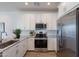 Bright kitchen with stainless steel appliances, granite counters, and white shaker cabinets at 9835 E Wavelength Ave, Mesa, AZ 85212