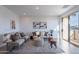 Bright and airy living room with a sliding glass door, neutral-toned furniture, and stylish decorative accessories at 9835 E Wavelength Ave, Mesa, AZ 85212