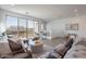 Spacious living area with open floor plan, comfortable seating, and scenic views from the balcony at 9835 E Wavelength Ave, Mesa, AZ 85212