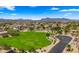 Community aerial view with lush park, mountain views, green spaces and well-maintained residential area at 10046 E Posada Ave, Mesa, AZ 85212